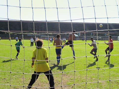 Garotos disputam bola em treino de futebol durante o dia em campo do Centro de Práticas Esportivas (Cepe)