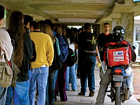 Motociclista transita entre fila no restaurante central (foto: Carol Nehring)